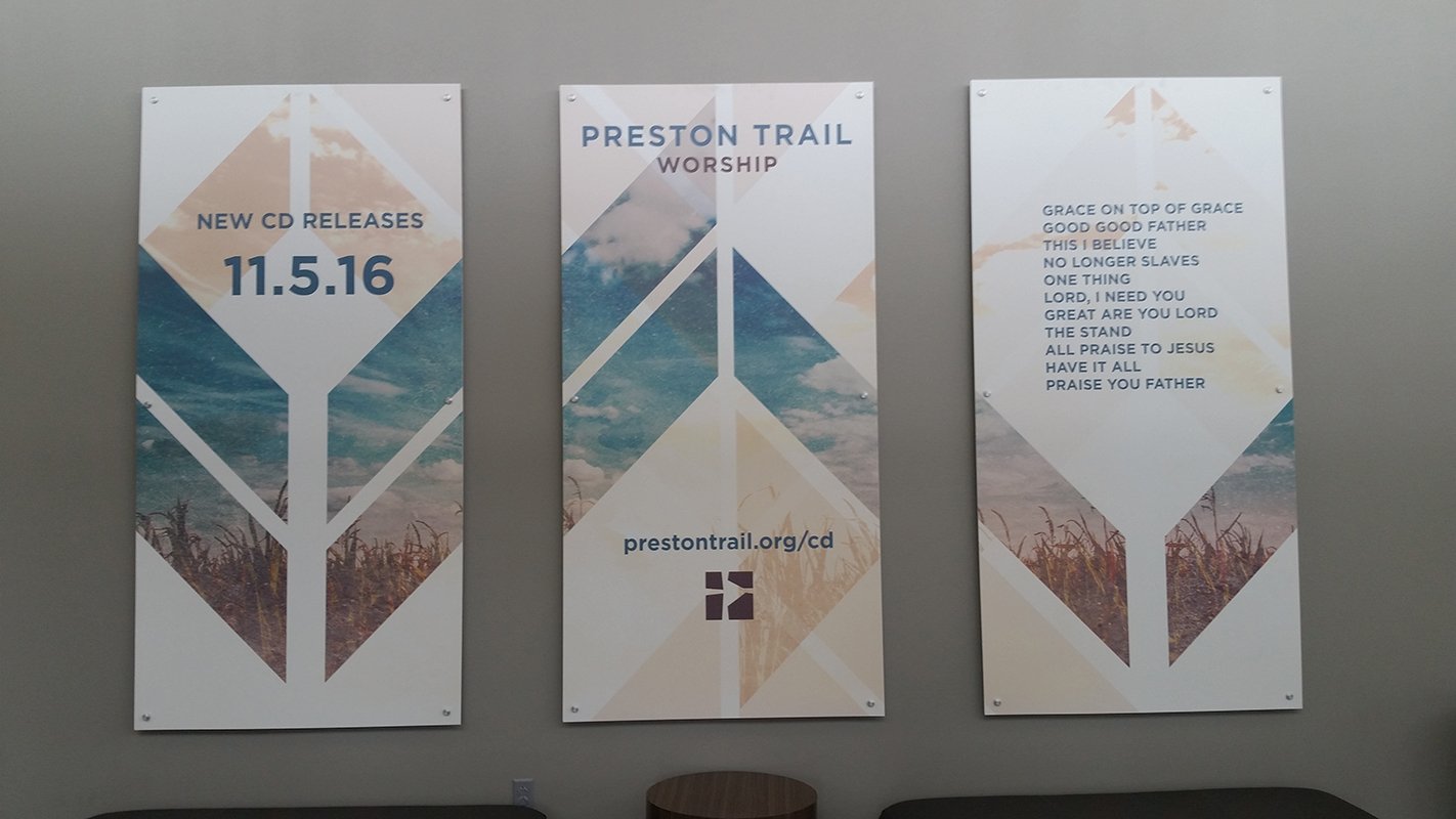 Three large format printed wall panels mounted in an interior space