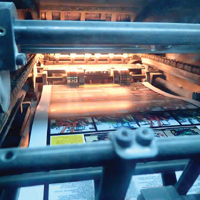 Commercial offset printing press producing printed sheets